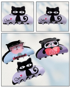 Detailed view of colorful cat and panda hair claws made from glossy acetate material