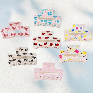 Set of seven colorful rectangular hair claws with floral and bow patterns for women