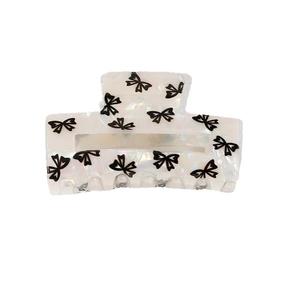 Chic pearlescent white acetate hair claw clip with black bow patterns for women