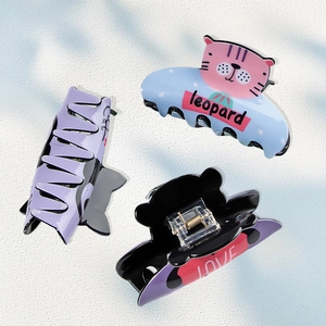 Three cute cat-shaped hair claws in blue purple and black with polka dots for girls