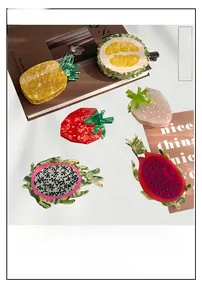 Collection of large acetate fruit hair clips including pineapple and strawberry patterns