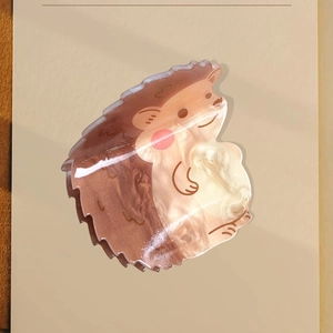 Cute cartoon hedgehog hair claw clip with brown and cream pearlescent acrylic finish