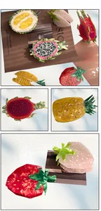 Close-up of acetic acid hair claw clips featuring fruit shapes like pitaya and pineapple