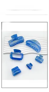 Detail shot of marble textured blue acrylic hair clips in various shapes and sizes