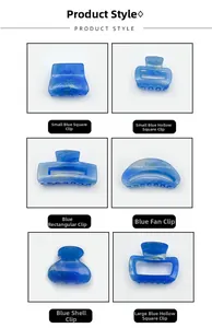 Detail view of six blue acrylic hair claw clips with elegant golden sand marble texture