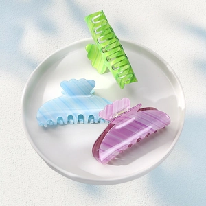 Three-piece set of acetate hair claws in pastel candy colors with elegant marble pattern