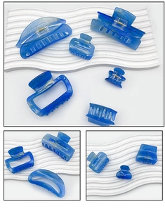 Detail view of blue marble texture acrylic hair claws in various shapes and sizes