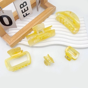 Minimalist amber acrylic hair claw clip set with marble texture and geometric shapes