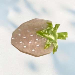 Pink acetate strawberry hair claw clip with glitter texture and green leaf accents