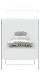 Detailed close-up of large marble white acrylic hair claw clip with pearlescent finish