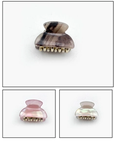 Detailed close-up of colorful acetate mini hair claws with marble and pearlescent textures