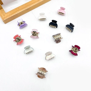 Set of 11 colorful mini acrylic hair claws for women in various marble and pastel tones