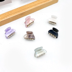 Mini acrylic hair claws in six colors including purple and white with pearl finish