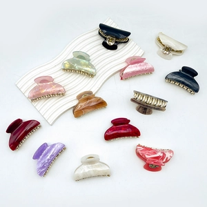 Collection of large acrylic shark hair claws with colorful marble patterns and metal teeth