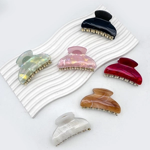 Set of six colorful marble pattern acrylic hair claws with elegant gold metal accents