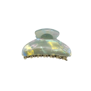 Iridescent acrylic hair claw clip with colorful aurora finish and gold metal teeth