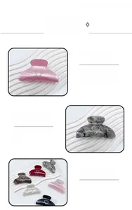 Detail view of heart-shaped rhinestones on marble pattern acrylic hair claw clip