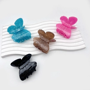 Pinze per capelli a farfalla in acrilico blu, rosa, ambra e nero con brillantini