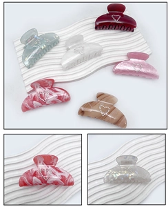 Detail of 6pcs acrylic heart hair claws featuring marble textures and rhinestone accents