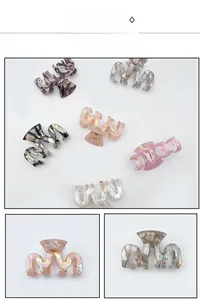 Detail view of colorful marble resin hair claws with a strong spring and geometric M-shape