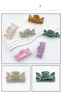 Macro shot of colorful marbled acrylic hair claw clips with secure metal springs