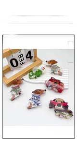 Detailed close-up of acrylic animal hair claws featuring dachshund and dalmatian designs