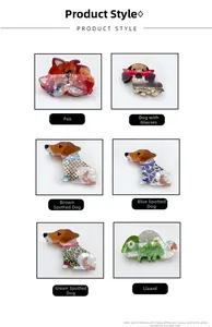 Detail view of acetate hair claws featuring cartoon dogs and lizards with marble patterns