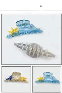 Detail view of shell-shaped acetate hair claws with starfish and whale decorations