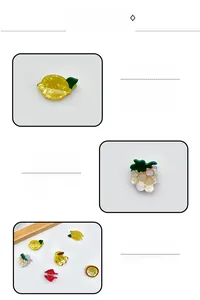 Macro detail of acrylic fruit-shaped hair clips with translucent pearlescent finish