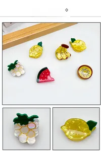 Detail of colorful acrylic fruit hair clips with 3D design and shimmering pearlescent finish
