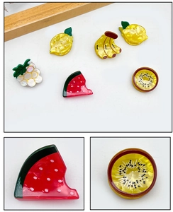 Macro view of colorful acrylic fruit hair clips including watermelon and kiwi designs