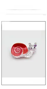 Detailed macro of a large acetate hair claw clip in a funny cartoon snail design