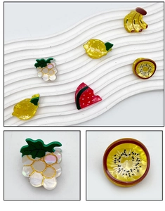 Detailed close-up of cute fruit-shaped acetate hair clips with vibrant pearlescent finish