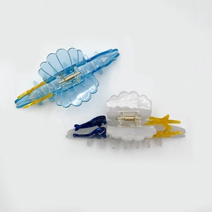 Elegant ocean themed acetate hair claws featuring blue shell texture and dolphin star fish motifs
