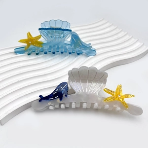 Elegant ocean-themed acetate hair claws featuring seashell starfish and whale designs