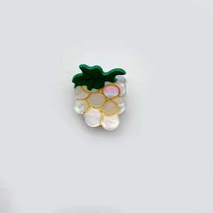 Cute grape-shaped acrylic hair claw clip with pearlescent finish and gold-trimmed edges
