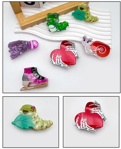 Detailed views of creative Halloween hair clips featuring heart bone hands and colorful snails