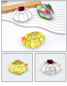 Detail of colorful shell hair claws with smiling face patterns and tiny rhinestones
