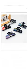 Detailed view of Halloween shark hair clips with skull and haunted house patterns