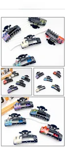 Detail showing skull hair claw clips with colorful accents and inlaid rhinestones