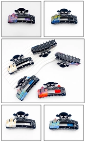 Detailed close-up of Halloween hair clips featuring spooky skulls and haunted castles