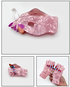 Close-up of pink marble texture hair claw clip in a creative hand-shaped design