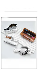 Detail of music-themed acrylic hair clips featuring piano and musical note patterns
