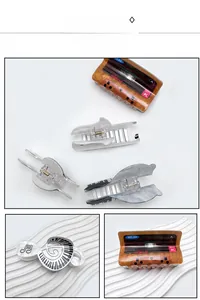 Detail view of retro cassette and musical note acrylic hair claws with marble texture