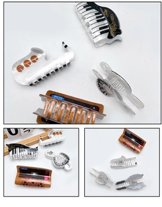 Detail showing musical instrument hair claws with piano keys and saxophone shapes