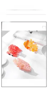 Detailed view of ocean-themed acetate hair clips in fish, jellyfish and crab designs