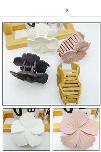 Detail view of matte flower hair claws in cream, pink, yellow, and coffee brown colors
