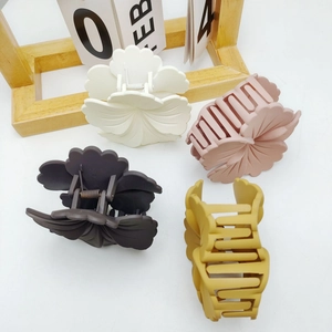 Floral claw clips set in cream, pink, brown, and yellow with matte finish for hair