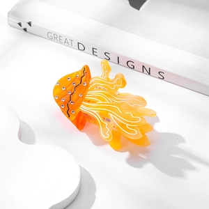 Chic orange jellyfish hair claw clip with crystal accents on a white display background