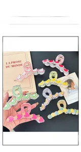 Detail view of large Korean-style fruit hair claws in translucent acrylic finishes